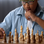 Boy with glasses playing chess