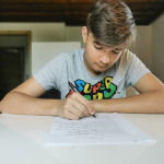 Boy writing on paper